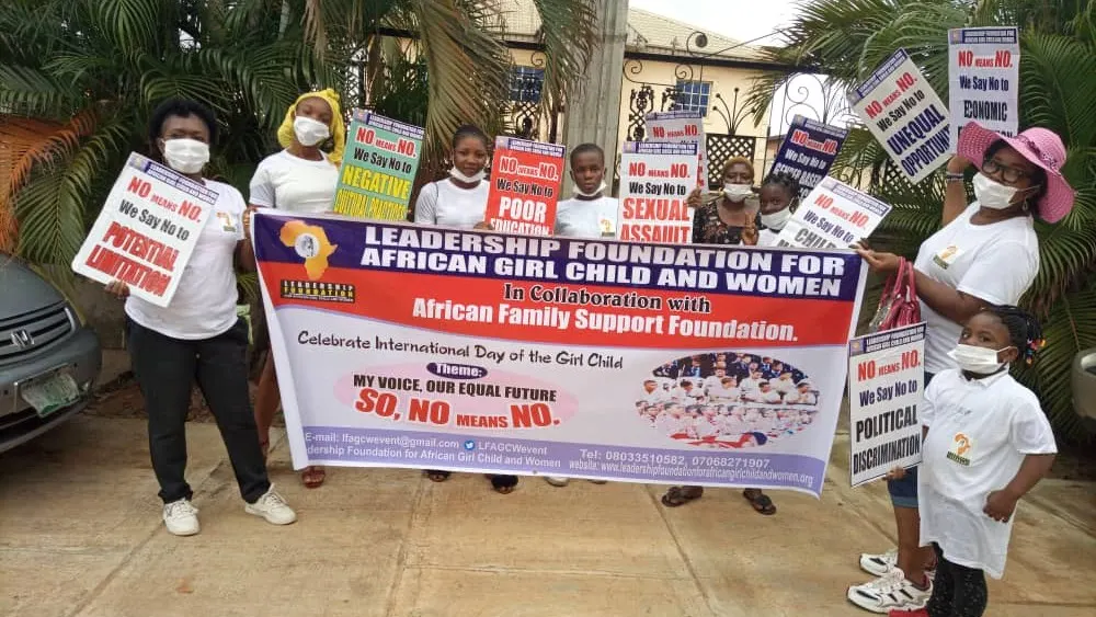 A stack of rice bags on a purple table next to the AFSF banner, prepared for community distribution.